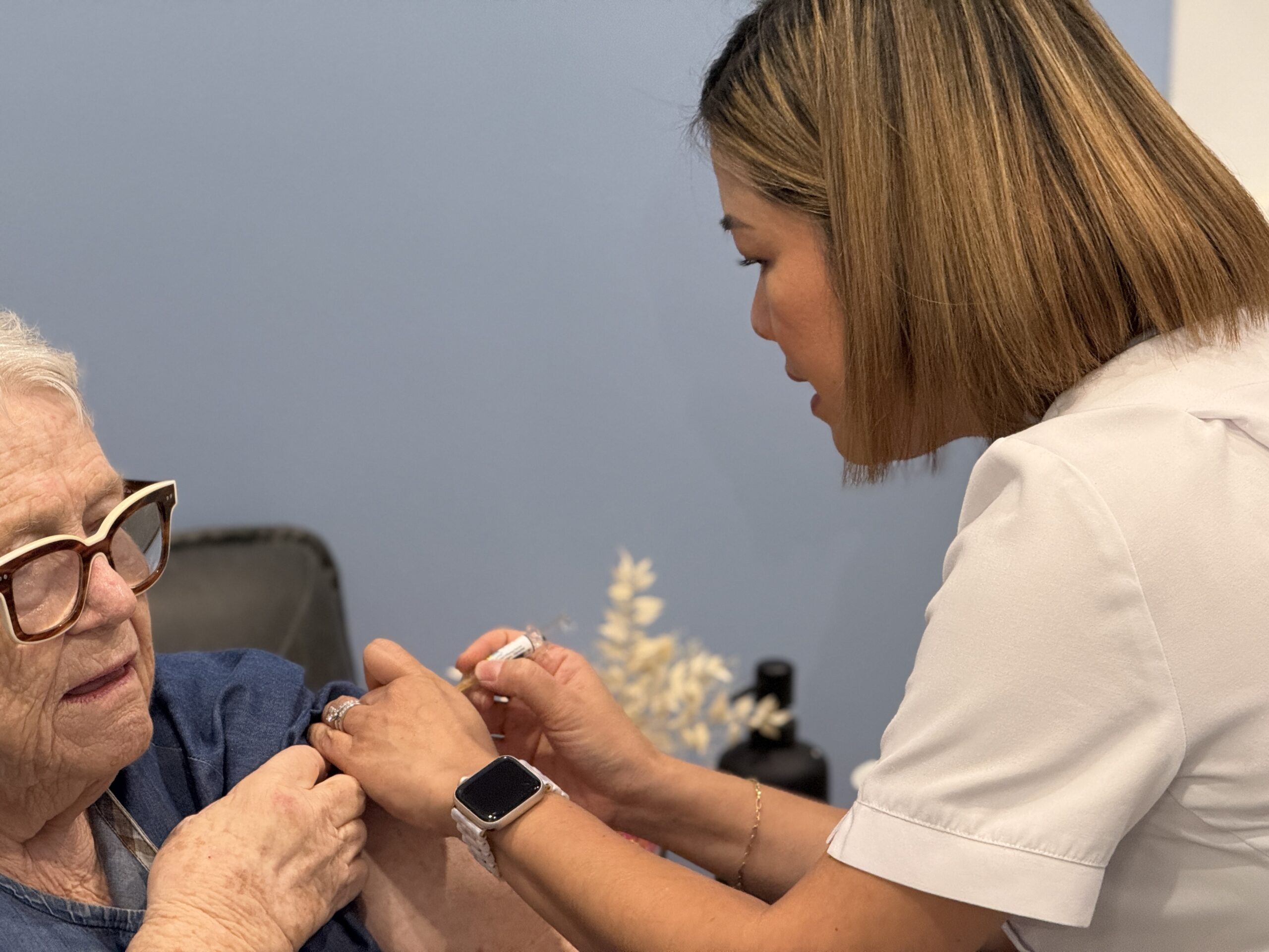 travel vaccines Brisbane — pharmacist administering vaccination at Coorparoo Marketplace Pharmacy